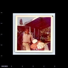 Square Color Photo MAN WITH SUNGLASSES STANDING OUTSIDE TRAILER HOME
