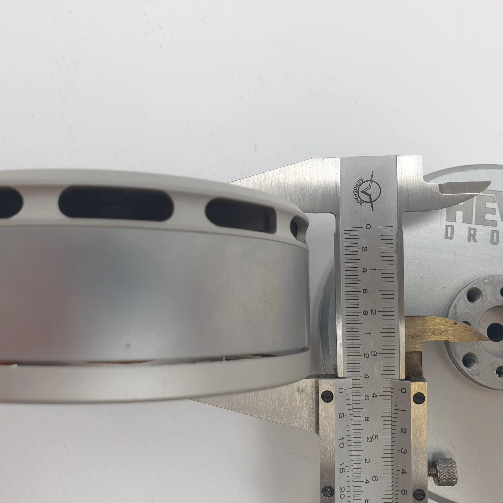 Caliper measuring the height of a KV100 motor