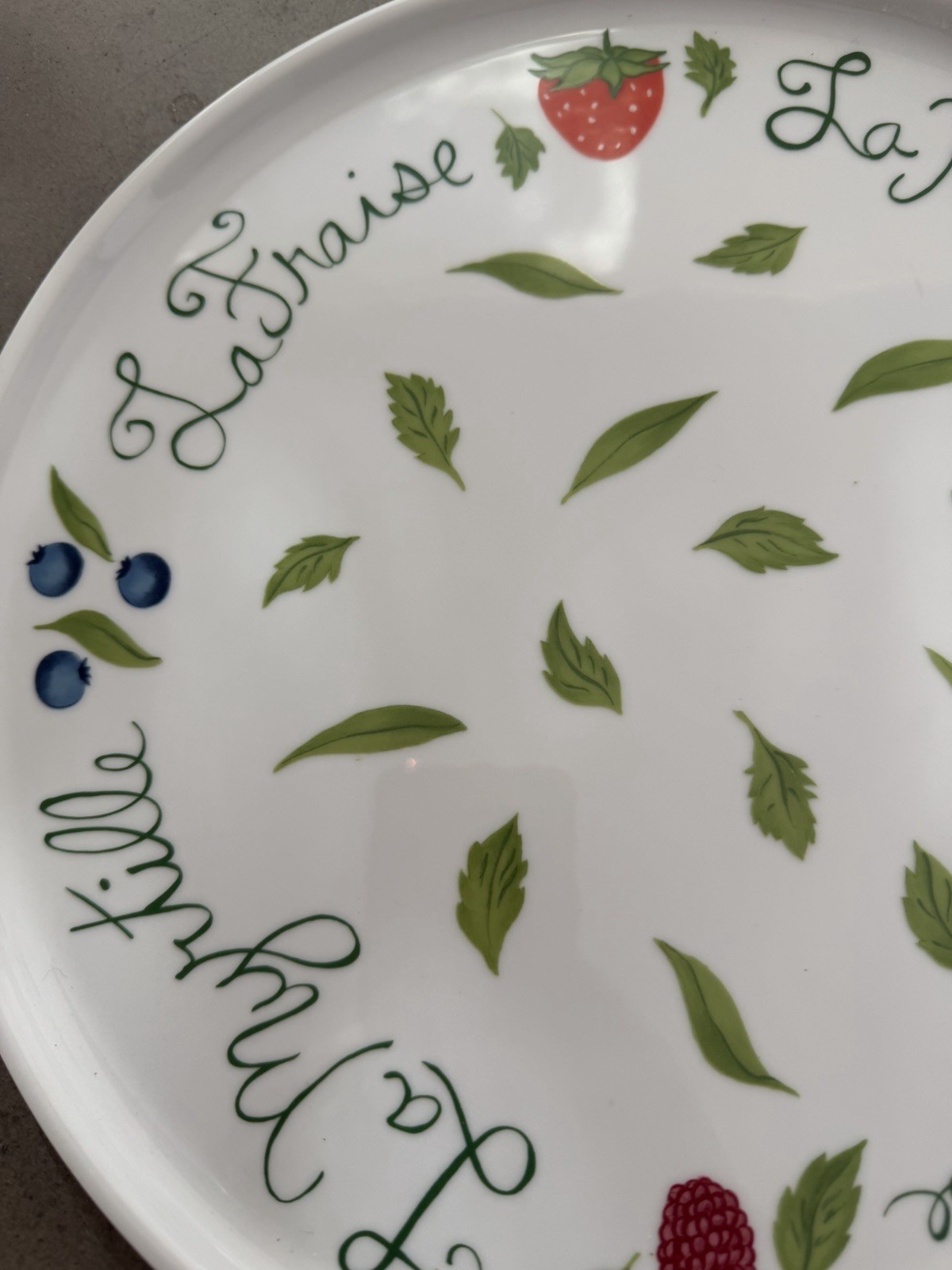 Philippe Deshoulieres Apilco porcelain plate with a fruit design. 11 7/8"