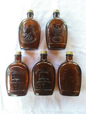 Lot of 7 Vintage Log Cabin Syrup 1776-1976 5 Amber and 2 Clear Bottles