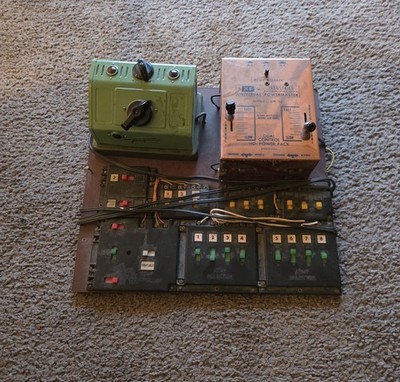 vintage model train control board with a transformer and various Switches