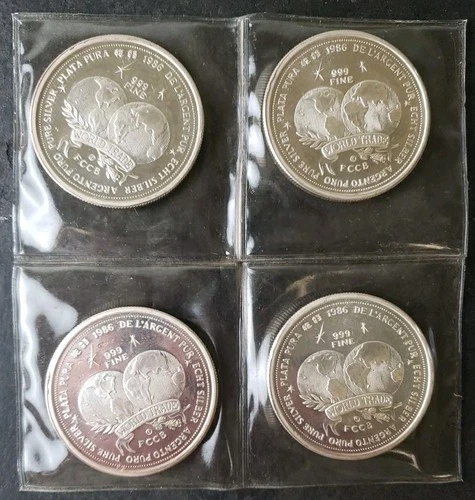 Lot of Four 1986 1oz Silver World Trade Unit Rounds in Plastic