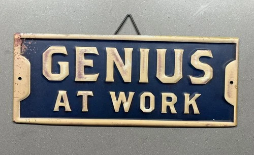 Old VTG Metal Sign Genius At Work Bar Garage Shop Business Home
