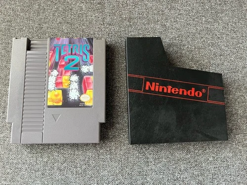 This is for a vintage Nintendo NES Tetris 2 game with black game sleeve.