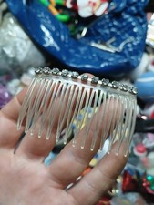 vintage-style plastic hair comb featuring a decorative row of rhinestones.