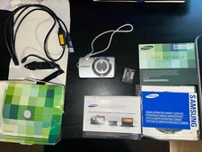 Samsung PL20 Silver Digital Camera 5X Zoom 14.2 MP w/ Battery Charging Cord