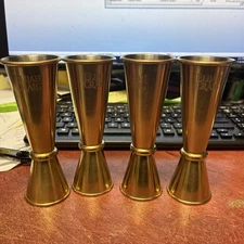 SET OF  4 ELIJAH CRAIG DOUBLE JIGGER 1 OZ / 2 OZ BRASS TONE COCKTAIL. BRAND NEW