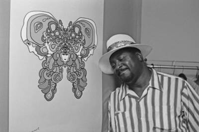 Albert King with a poster featuring the Peter Max 1971 Old Music Photo