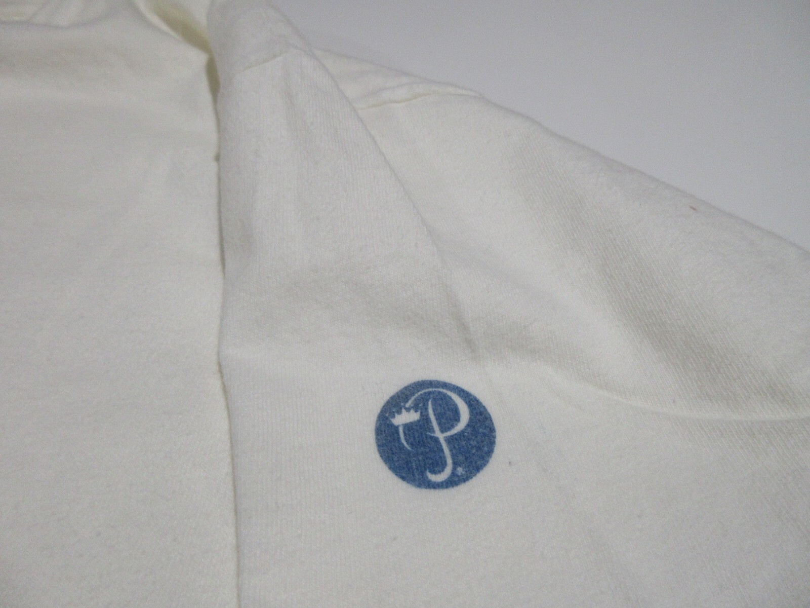 White short-sleeve Sz L Vtg Bermuda cotton T-shirt with blue monogram logo on left chest, small white text “Sz L” on sleeve.