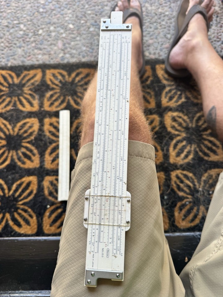 A genuine Japanese-made Ricoh slide rule with its cursor intact — analog computing in your hand, and it still works perfectly.