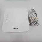 White Eero 6+Plus dual band mesh WiFi router with black top panel, visible rear Ethernet ports, and attached white power cable.