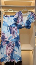 Two-piece matching set. Crop top: puff sleeves, V-neck. High-waisted maxi skirt.