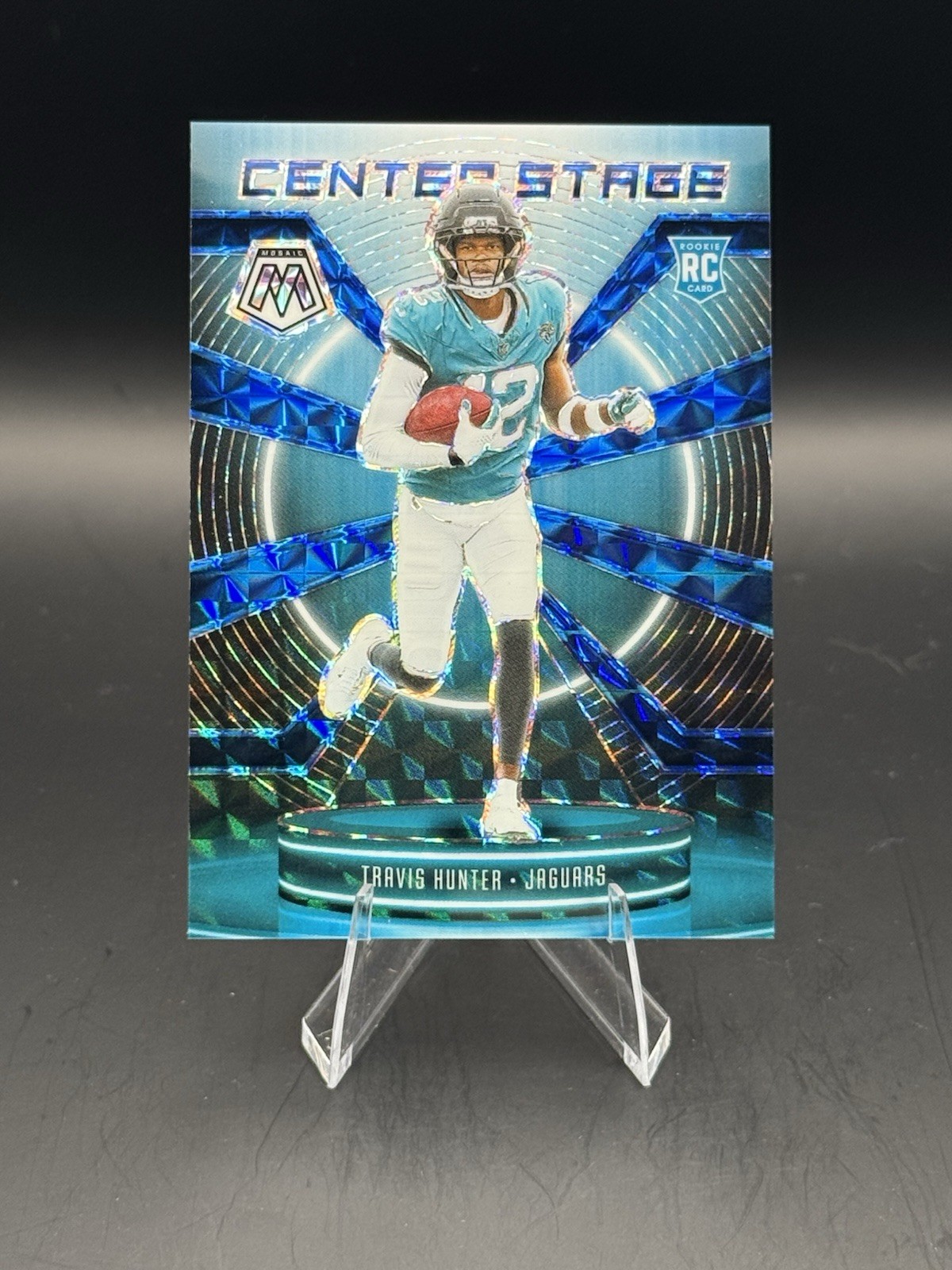 2025 Panini Mosaic - Center Stage Mosaic Travis Hunter #20 Blue Prizm /99 (RC)