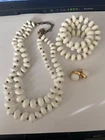 set of vintage costume jewelry, likely made of milk glass or Lucite beads from t