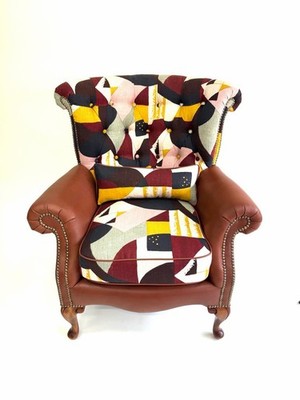 Selling A Stylish Armchair Featuring Brown Leather and A Colorful Design