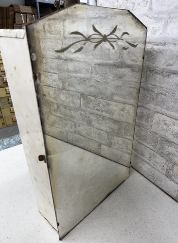 vintage metal medicine cabinet with a mirrored door and decorative etching