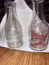 2 Quart Milk Bottles 1 Is Superior Dairy Co. and the other is Norman H Shaw