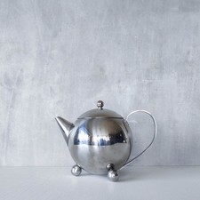 Vintage stainless steel teapot with ball feet