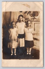 RPPC 3 young girls kids dresses no smile sad Postcard Portrait Real Photo Vtg