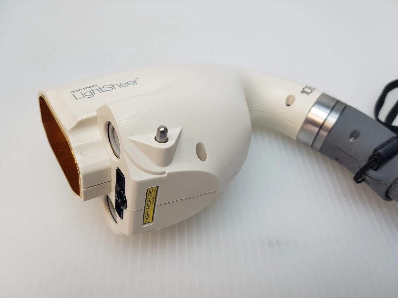 LightSheer handpiece head with yellow LASER APERTURE label