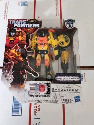 TRANSFORMERS Generations Thrilling 30 Voyager Class Sandstorm Triple changer 
