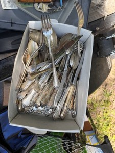 Lots of spoons forks and knifes 