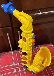 NWOB TOY Saxophone by Small World Toys Play At Home 18 Songs, 4 Blinking Lights