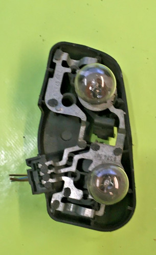 Tail light bulb cover holder