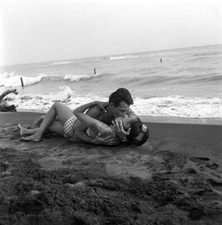 Walter Chiari and the actress Seyna Seyn lying on the sand and kis- Old Photo