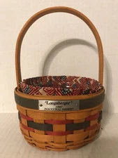 1997 LONGABERGER ROUND INAUGURAL BASKET WITH STATIONARY HANDLE 3" HIGH
