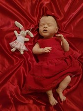 baby snuggles drink and wet doll