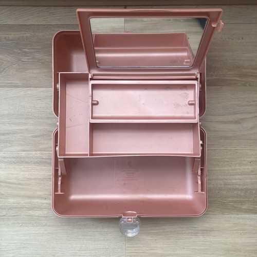 Pink Caboodle makeup case with clear window, two front drawers, and silver screw-on lid.
