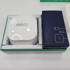 White Eero 6+Plus dual band mesh WiFi router box with black top and side, next to black power adapter box.