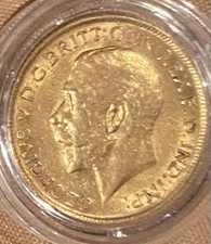 A 1911 King George full 22ct gold Sovereign coin fully encapsulated 