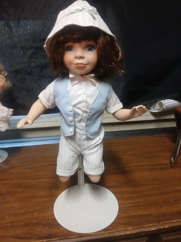 Doll Figure Brown Hair Light Complexion White Outfit Blue Vest White Hat Stand