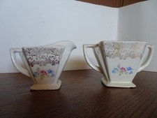 Antique Art Deco ceramic Cream and Sugar set. irredicent gold w/ flower detail