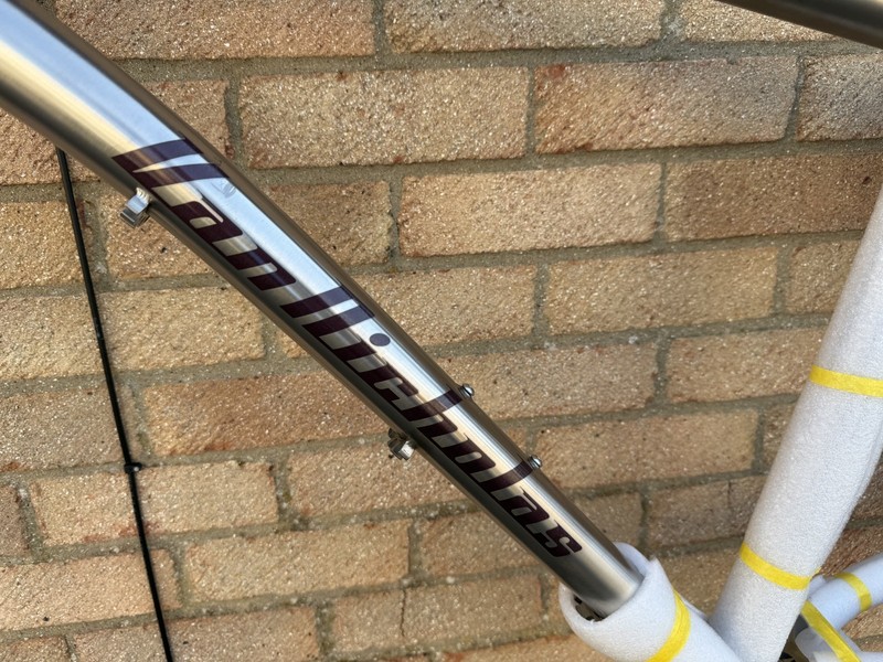 bike frame ( No forks ) The colour is silver & brown logo & black writing