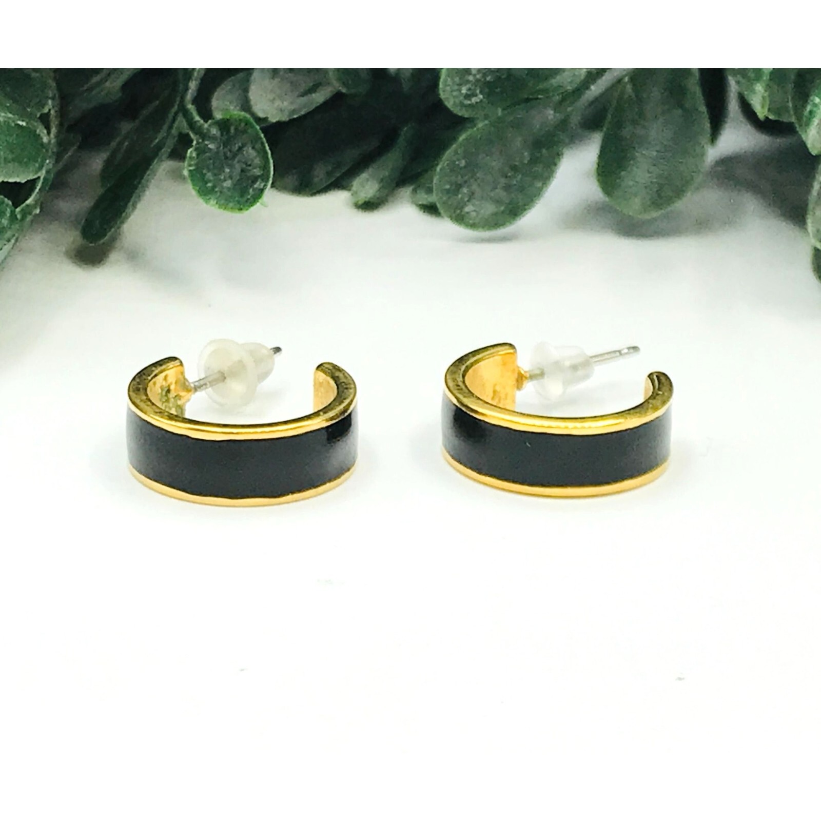Gold-tone hoop earrings with stylish black stripe accent  -image