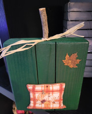 Fall, green wood block pumpkin with wood stem, tin star and pumpkins.