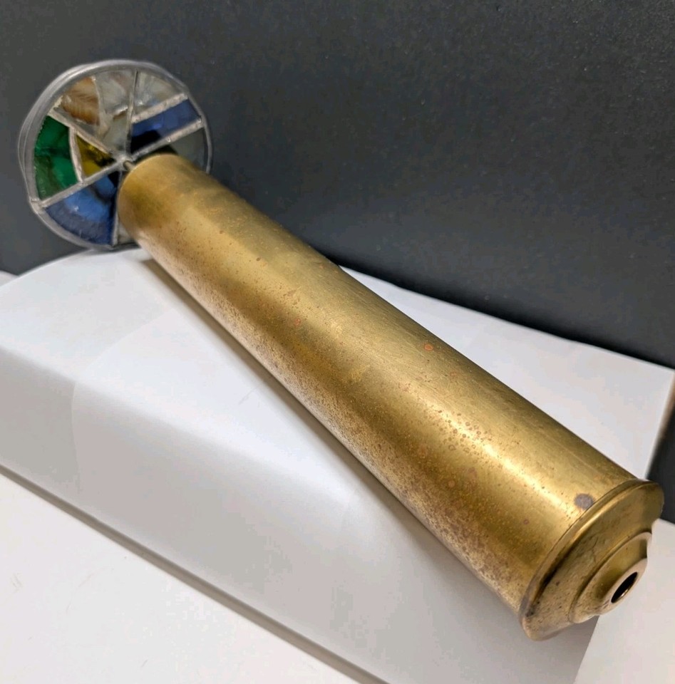 A 13" dual-wheel brass kaleidoscope with stained glass elements — a striking desk object that doubles as a meditative light show.