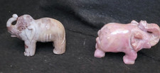 2 carved stone elephant figurines
