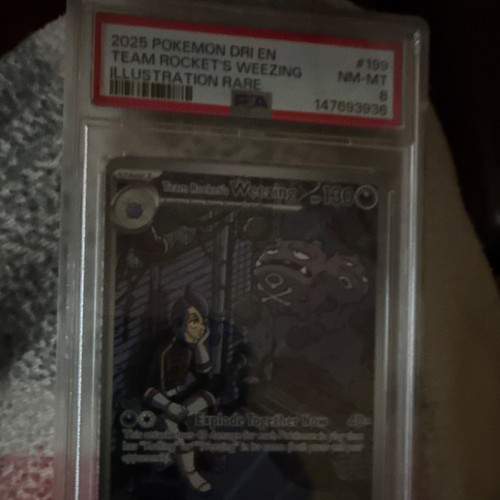 PSA 8 2025 Pokémon Team Rocket’s Weezing Illustration Rare holo card with silver-toned figure art in protective case.