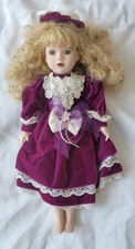 Vintage Porcelain Doll with Blonde Hair and Elegant Purple Magenta Dress
