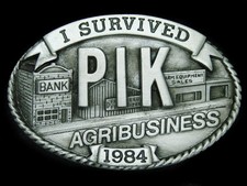 UB05107 NOS VINTAGE 1984  I SURVIVED PIK AGRIBUSINESS  COMMEMORATIVE BUCKLE