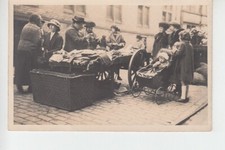 RPPC 1930's scene at market barrow selling second hand clothes.