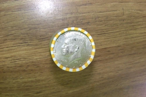 Kennedy half dollar roll with a 40% silver 1969-D  half on end in vV- good cond.