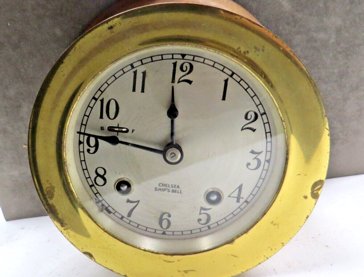 CHELSEA SHIP'S BELL CLOCK, WITH KEY, MOUNTED ON ROUND WOODEN BASE, 3 5/