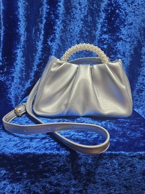 Chic metallic silver mini bag with a pearl-accented top handle, Lightweight.