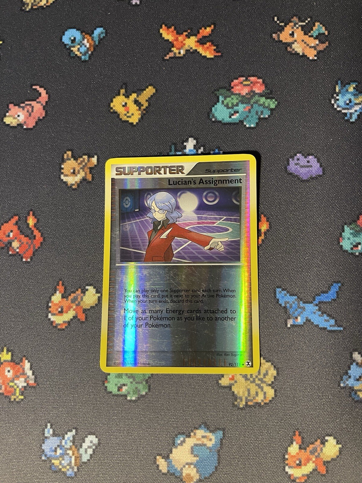 Pokémon Card Lucian’s Assignment 92/111 Rising Rivals Reverse Holo - (LP)