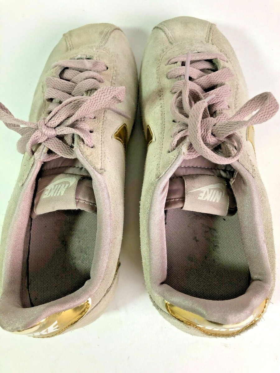 pink nike cortez with gold swoosh